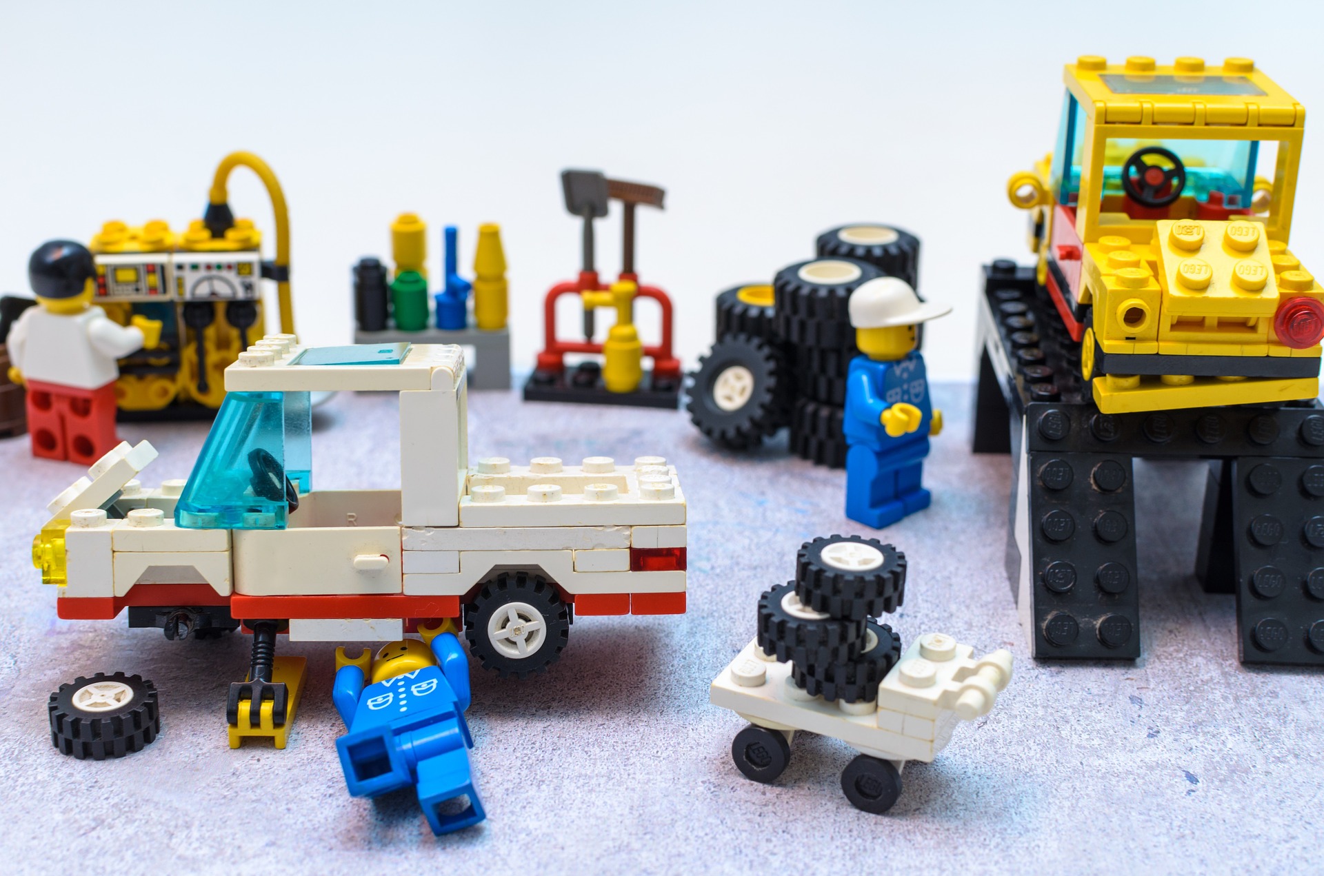A variety of cars and trucks made out of LEGO bricks.