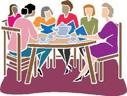 group of grown women sitting around a table 