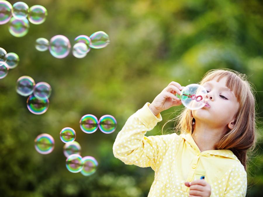 girl blowing bubbles