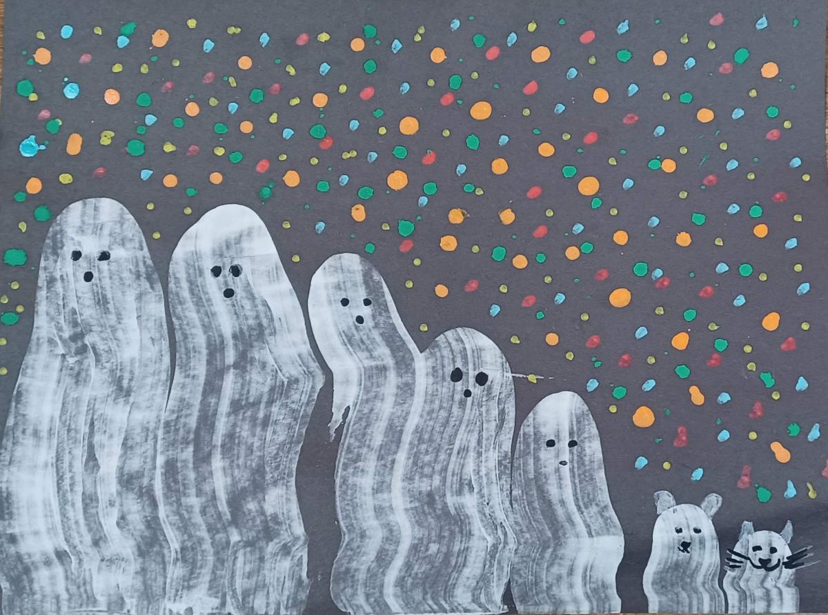 A black paper with cute ghostly figures, including a cat and dog